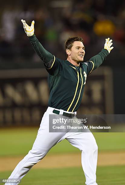 John Jaso of the Oakland Athletics celebrates after he hit a walk-off RBI double scoring Nick Punto to defeat the Washington Nationals in the Bottom...