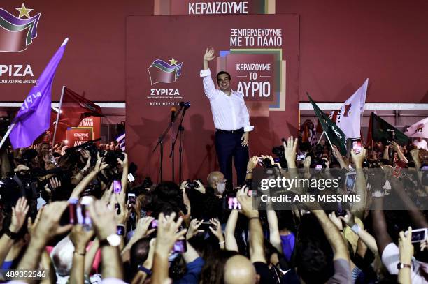 Leader of the Greek radical-left Syriza party Alexis Tsipras waves to his supporters as he arrives at the main party's election headquarters in...