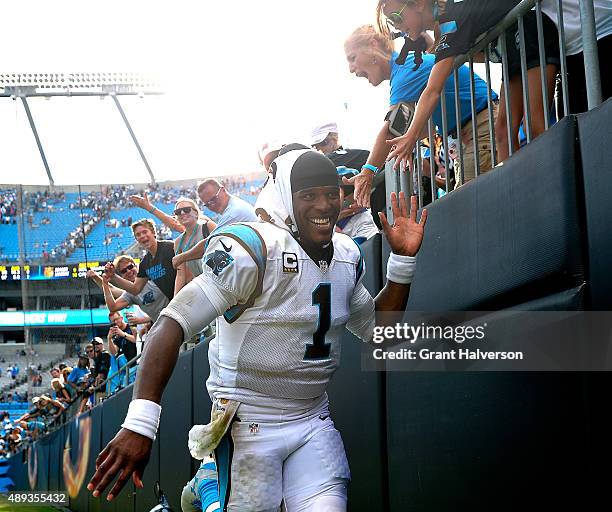 Cam Newton of the Carolina Panthers celebrates with fans after a win against the Houston Texans at Bank of America Stadium on September 20, 2015 in...