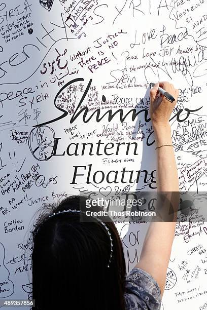 Guest participates in the Shinnyo Lantern Floating for Peace Ceremony at Lincoln Center for the Performing Arts on September 20, 2015 in New York...
