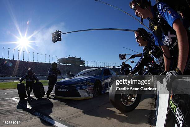Clint Bowyer, driver of the PEAK Antifreeze & Coolant Toyota, pits during the NASCAR Sprint Cup Series myAFibRisk.com 400 at Chicagoland Speedway on...