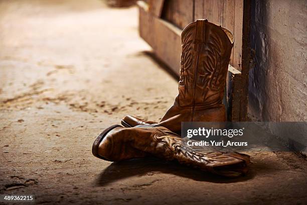 tossed aside after a long day - cowboy boots stock pictures, royalty-free photos & images