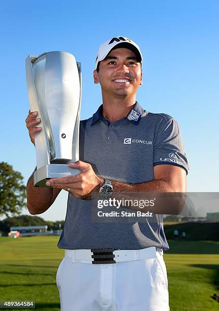 Jason Day of Australia celebrates with the winner's trophy after the final round of the BMW Championship at Conway Farms Golf Course on September 20,...