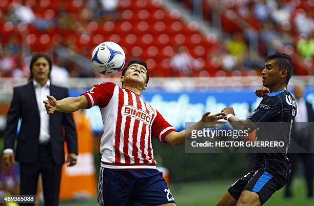 Michael Perez of Guadalajara vies for the ball with Orbelin Pineda of Queretaro during their Mexican Apertura 2015 tournament football match at...