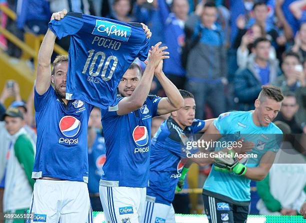 Federico Insua of Millonarios celebrates after scoring the opening goal showing a jersey with the number "100" and his nickname "Pocho" during a...