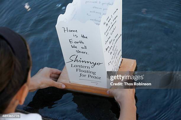 Guest participates in the Shinnyo Lantern Floating for Peace Ceremony at Lincoln Center for the Performing Arts on September 20, 2015 in New York...