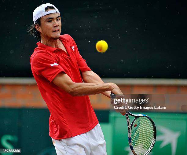 Taro Daniel of Japan returns a backhand shot during the Davis Cup World Group Play-off singles match between Alejandro Falla of Colombia and Taro...