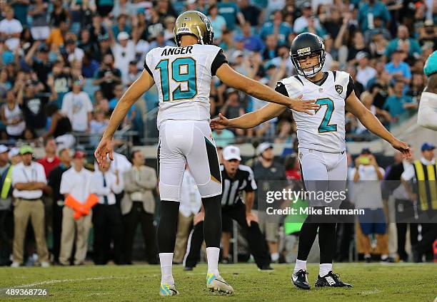 Jason Myers of the Jacksonville Jaguars is congratulated by Bryan Anger after kicking the game winning field goal during a game against the Miami...