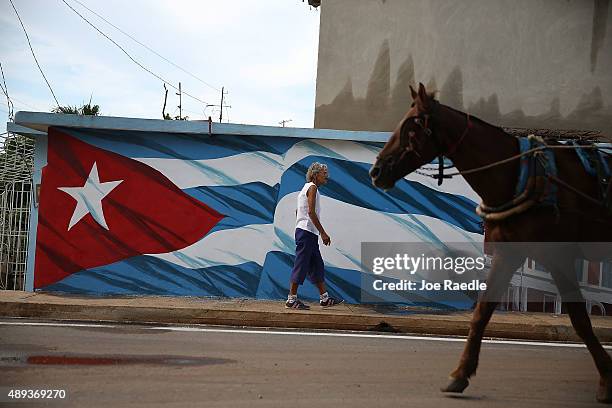 Cuban flag is seen painted on a wall along the street Pope Francis is scheduled to drive through on September 20, 2015 in Holguin, Cuba. Pope Francis...