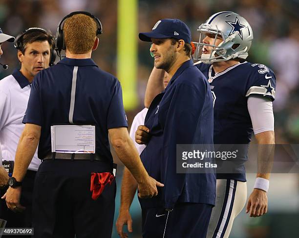 Tony Romo of the Dallas Cowboys talks with head coach Jason Garrett and quarterback Brandon Weeden in the fourth quarter against the Philadelphia...