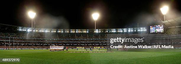 Teams line up for the national anthem during the 2015 AFL Second Semi Final match between the Hawthorn Hawks and the Adelaide Crows at the Melbourne...