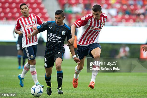 Jorge Enriquez of Chivas, fights for the ball with Orbelin Pineda of Queretaro during a 9th round match between Chivas and Queretaro as part of the...