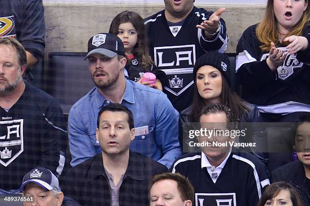 Stephen Amell and Cassandra Jean attend an NHL playoff game between the Anaheim Ducks and the Los Angeles Kings at Staples Center on May 10, 2014 in...