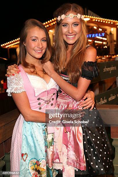 Alena Gerber and her sister Deborah Gerber attend the Almauftrieb during the Oktoberfest 2015 at Kaeferschaenke beer tent on September 20, 2015 in...