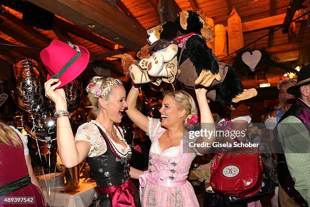 Barbara Sturm and Jennifer Knaeble with hat attend the Almauftrieb during the Oktoberfest 2015 at Kaeferschaenke beer tent on September 20, 2015 in...