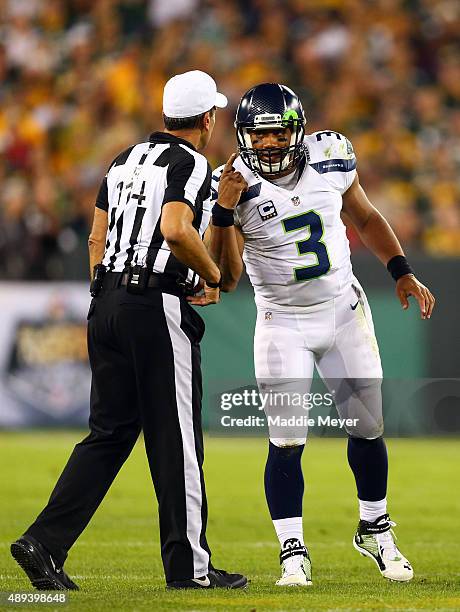 Russell Wilson of the Seattle Seahawks argues with referee Gene Steratore after a play against the Green Bay Packers during their game at Lambeau...