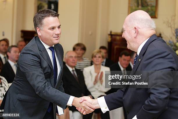 Cities and Built Environment Minister Jamie Briggs is congratulated by Governor-General Sir Peter Cosgrove during the swearing-in ceremony of the new...