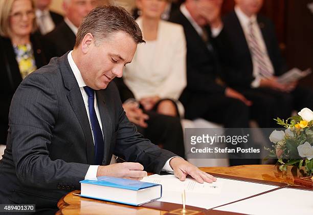 Cities and Built Environment Minister Jamie Briggs is sworn in by Governor-General Sir Peter Cosgrove during the swearing-in ceremony of the new...
