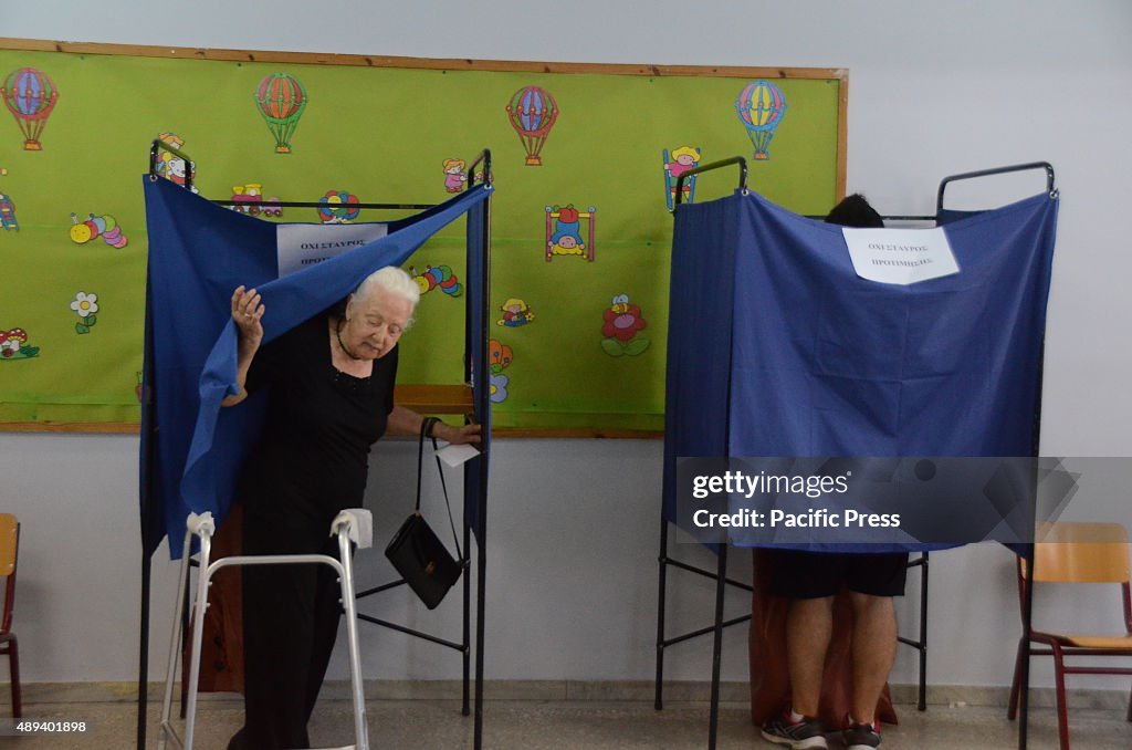 Greek citiens visit polling centers all over Greece to cast...