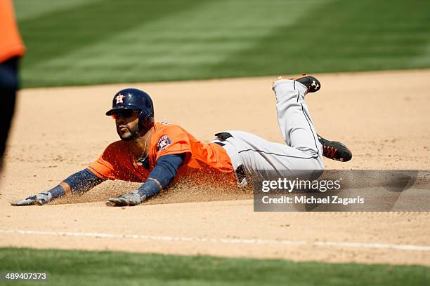 Hoes of the Houston Astros sldies into third during the game against the Oakland Athletics at O.co Coliseum on April 19, 2014 in Oakland, California....