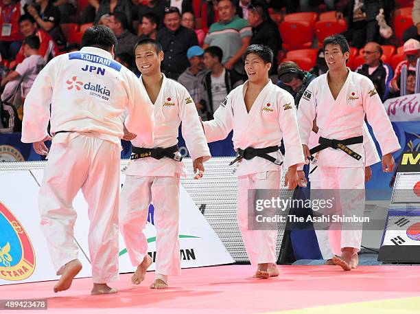 Takeshi Ojitani, Masashi Ebinuma, Riki Nakaya and Takanori Nagase of Japan celebrate winning the gold after beating South Korea in the Men's Team...