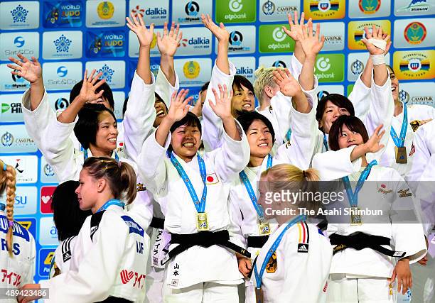 Gold medalists Team Japan celebrates on the podium at the medal ceremony for the Women's Team during the 2015 Astana World Judo Championships at the...