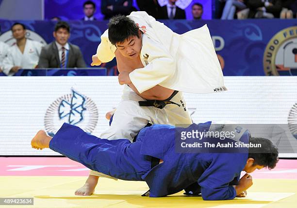 Takeshi Ojitani of Japan and Kim Sung-min of South Korea compete in the Men's team final during the 2015 Astana World Judo Championships at the Alau...