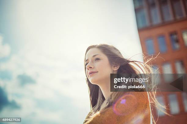 girl enjoying sunlight with dreamy look - portrait daydreaming stock pictures, royalty-free photos & images