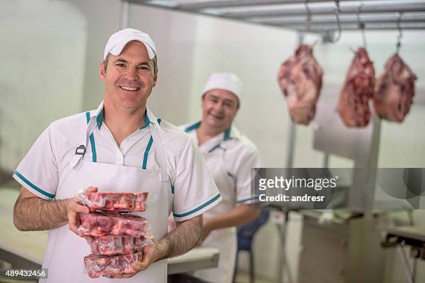 men working at the butchery - slagerij stockfoto's en -beelden