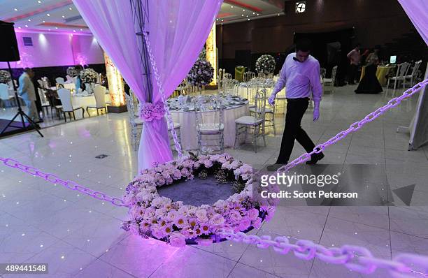 An Iranian wedding hall is prepared for a luxury wedding with mixed dancing and removal of headscarves, at a private garden tailor-made for the...