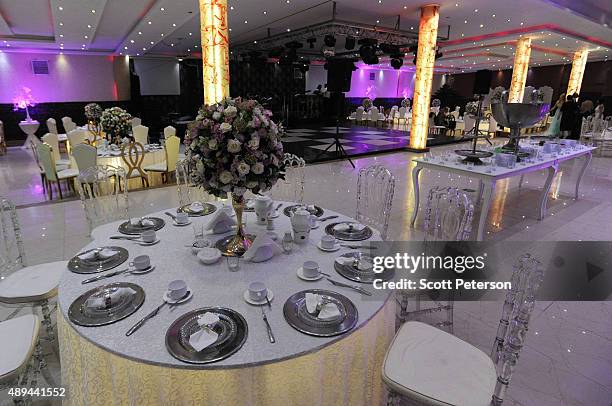 Iranian tables are prepared for a luxury wedding with mixed dancing and removal of headscarves, at a private garden tailor-made for the purpose west...