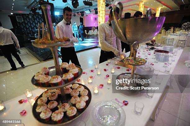 Iranian tables are prepared for a luxury wedding with mixed dancing and removal of headscarves, at a private garden tailor-made for the purpose west...