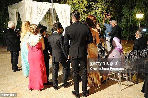 Iranian families take part in a luxury wedding with mixed dancing and removal of headscarves, at a private garden tailor-made for the purpose west of...