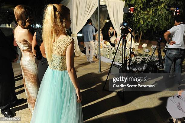 Iranian families take part in a luxury wedding with mixed dancing and removal of headscarves, at a private garden tailor-made for the purpose west of...