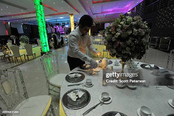 Iranian tables are prepared for a luxury wedding with mixed dancing and removal of headscarves, at a private garden tailor-made for the purpose west...