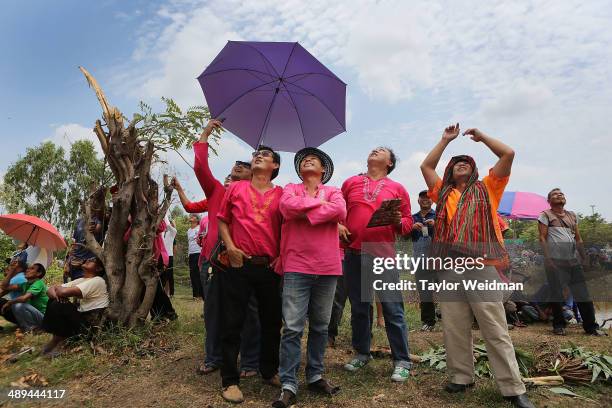 Thai residents watch the launch of enormous homemade rockets during the Bun Bang Fai festival on May 11, 2014 in Yasothon, Thailand. During the Bun...