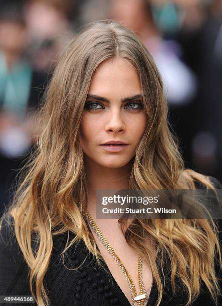 Cara Delevingne attends the Burberry Womenswear Spring/Summer 2016 show during London Fashion Week at Kensington Gardens on September 21, 2015 in...