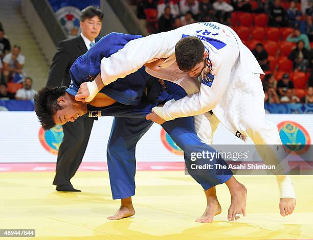 Ryunosuke Haga of Japan and Cyrille Maret of France compete in the Men's -100kg semifinal during the 2015 Astana World Judo Championships at the Alau...