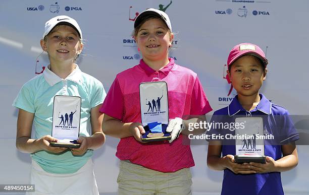 Girls 7-9 age group Chip top three, third place Kate Bennett, first place June Doerr, second place Maye Huang pose with their medals during a...