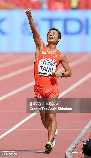 Takayuki Tanii of Japan celebrates after crossing the finish line to win bronze in the Men's 50km Race Walk final during day eight of the 15th IAAF...