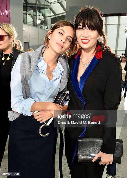 Alexa Chung and Daisy Lowe attend the Christopher Kane show during London Fashion Week SS16 at Sky Garden on September 21, 2015 in London, England.