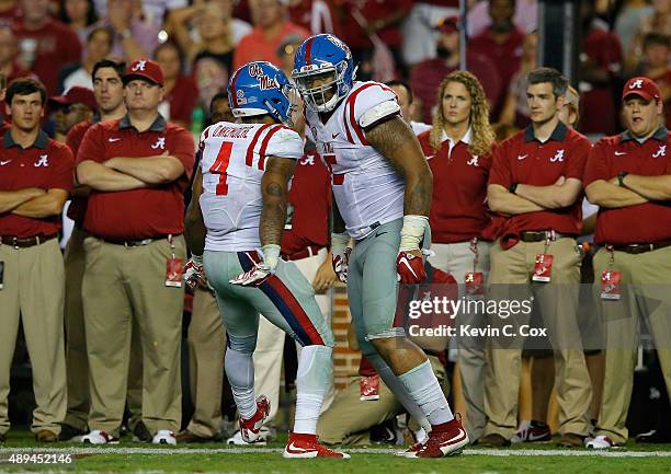 Robert Nkemdiche and Denzel Nkemdiche of the Mississippi Rebels react after a defensive stop at Bryant-Denny Stadium on September 19, 2015 in...