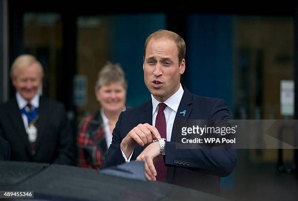 Prince William, Duke Of Cambridge points at his watch as he leaves his visit to Hammersmith Academy to support the Diana Award's #Back2School...