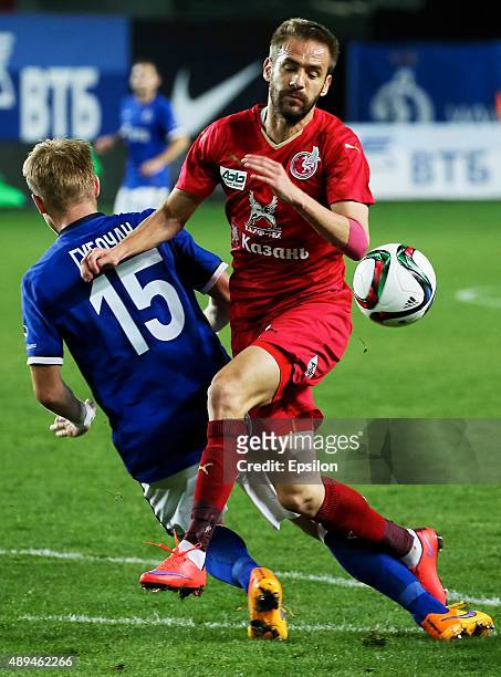 Tomash Hubochan of FC Dinamo Moscow is challenged by Marko Devic of FC Rubin Kazan during the Russian Premier League match between Dinamo Moscow and...