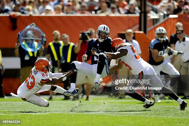 Cornerback Joe Haden and linebacker Craig Robertson of the Cleveland Browns tackle quarterback Marcus Mariota of the Tennessee Titans during a game...