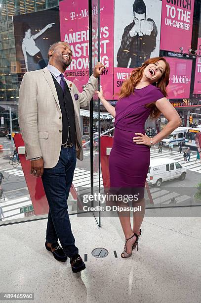 Calloway interviews Debra Messing during her visit to "Extra" at their New York studios at H&M in Times Square on September 21, 2015 in New York City.