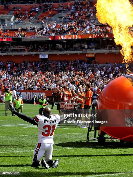 Safety Donte Whitner of the Cleveland Browns goes to his knees as he is introduced to the crowd prior to a game against the Tennessee Titans on...