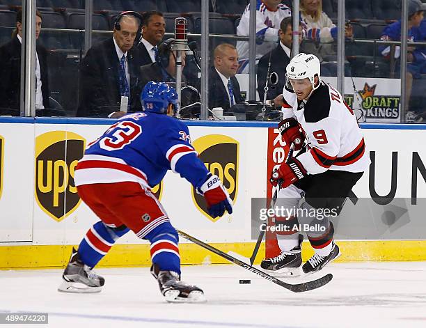 Jiri Tlusty of the New Jersey Devils skates against Raphael Diaz of the New York Rangers during their Pre Season game at Madison Square Garden on...