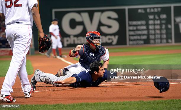 Mikie Mahtook of the Tampa Bay Rays slides into home base safely in the first inning against the Boston Red Sox at Fenway Park on September 21, 2015...