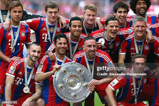 Franck Ribery and Claudio Pizarro of Bayern Muenchen hold the Bundesliga championship trophy in celebration after the Bundesliga match between Bayern...